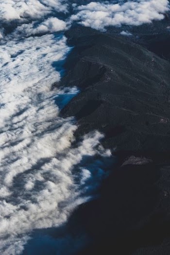 white clouds on black mountain