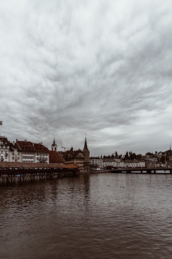 White Clouds on Top of Brown and White Buildings
