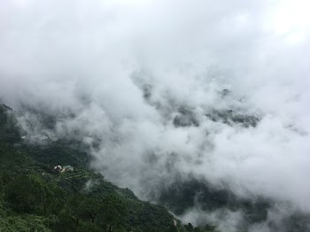 white clouds over a mountain
