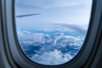 white clouds through clear glass window at daytime