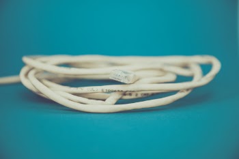 White Coated Cable on Teal Surface