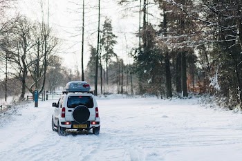 white compact van at snow path