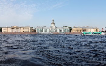 White Concrete Building Across Body of Water