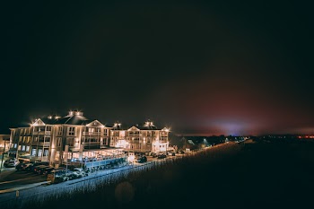 White Concrete Building Beside Body of Water during Nighttime