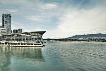 White Concrete Building Near Body of Water Under Blue Sky