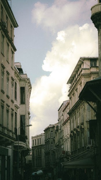 White Concrete Building Under White Clouds · Free Stock Photo