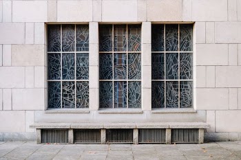 white concrete building with blue windowpane