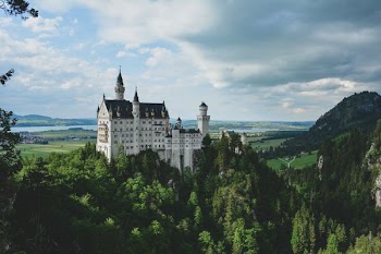 white concrete castle in green field