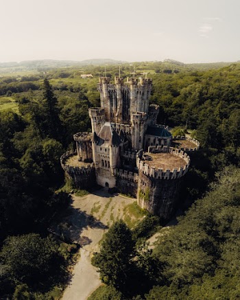 White Concrete Castle Surrounded With Trees