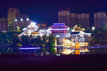White Concrete House Beside Large Body of Water during Nightime