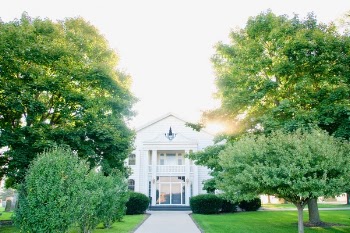 White Concrete House Between of Green Trees