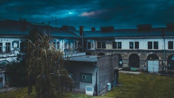 white concrete house in front of tree