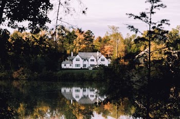 white concrete house near river