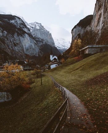 white concrete house surrounded by mountains