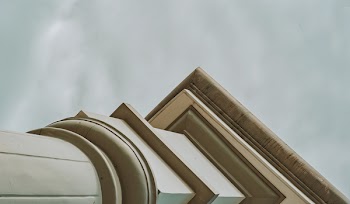 White Concrete Pedestal Column Facing the Rainy Sky