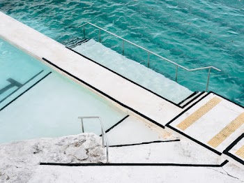 White Concrete Platform Beside Body of Water