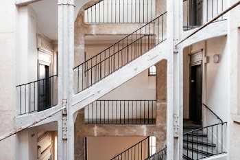 white concrete staircase with black steel handrails