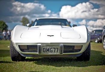 White Corvette C3 With Omg77 License Plate on Display