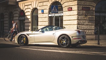 White Coupe Beside Grey Concrete Building
