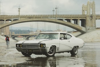 White Coupe on Body of Water Near Bridge