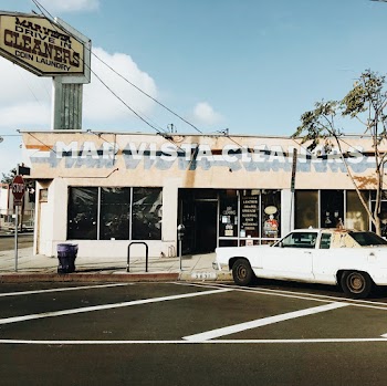 White Coupe Parked Outside Store