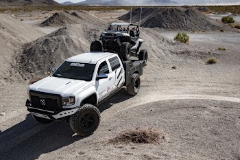 White Crew Cab Pickup Truck Running on Dirt Road