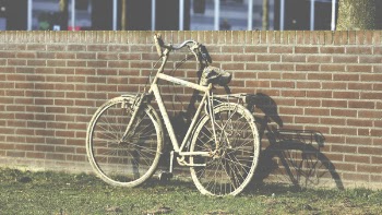 White Cruiser Bicycle Parked Beside Brown Building