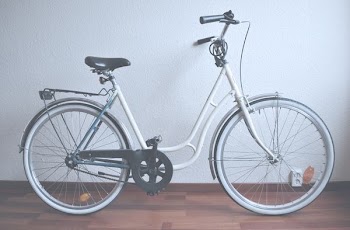white cruiser bike on brown parquet floor