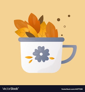 white cup decorated with autumn leaves