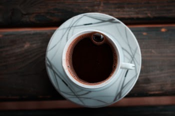 White Cup on Saucer on Brown Wooden Table