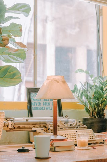White Desk Lamp Beside White Plastic Cup