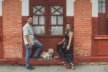 White Dog Between Smiling Man and Woman