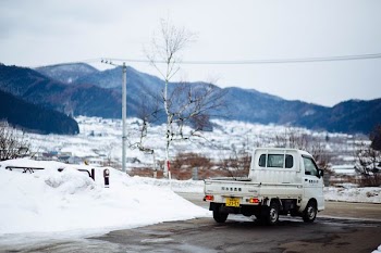 white drop side truck on road during winter season