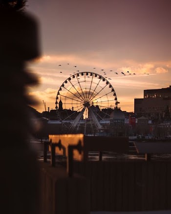 white ferris wheel under cloudy