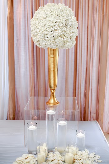 White Flower Centerpiece on Clear Glass Box With Candles