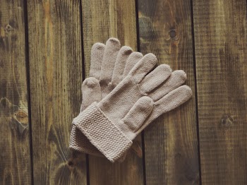 White Gloves on Brown Wooden Surface