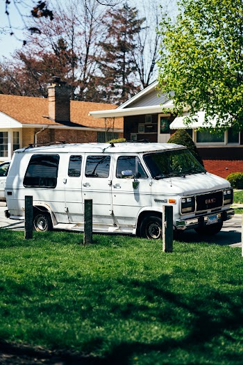 White Gmc Custom Van Parked in Driveway
