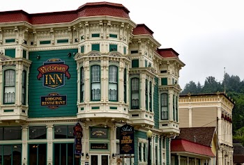 White, Green, and Red Victorian Inn Lodging Restaurant Building Near Trees