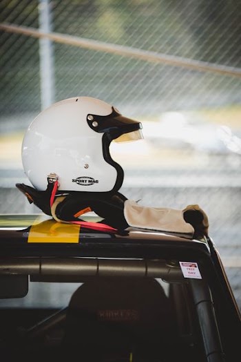 white half-face helmet on vehicle rooftop