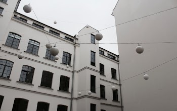 White Hanging Light Balls in Front of White Building
