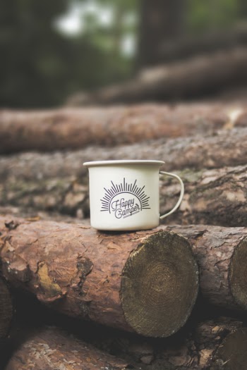 White Happy Camper-printed Cup on Brown Wooden Log