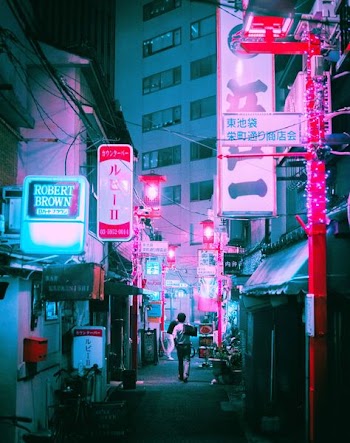 white high-rise building surrounded with pink store signage