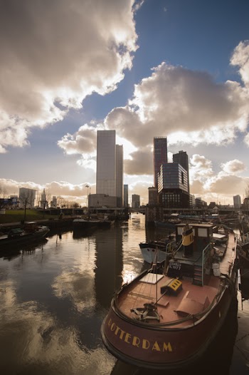 White High-rise Building Under Cloudy Sky