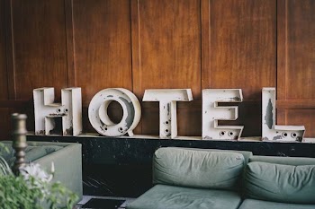 white Hotel signage near sofa