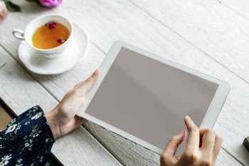White Ipad on Hand