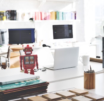 White Laptop Computer on White Desk