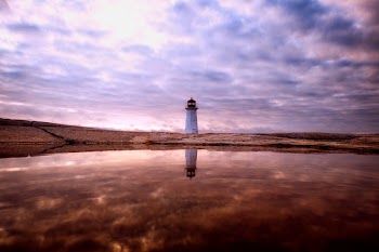 White Lighthouse Near Body of Water