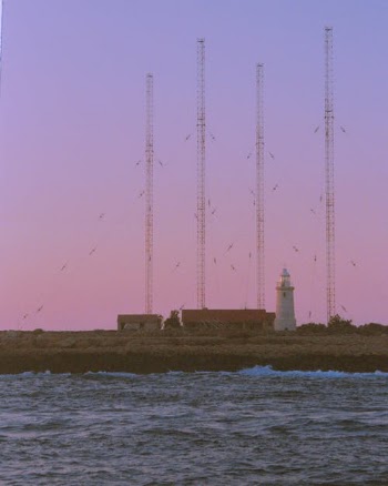 White Lighthouse Near Body of Water · Free Stock Photo