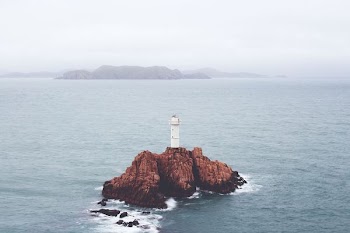 white lighthouse on island during daytime
