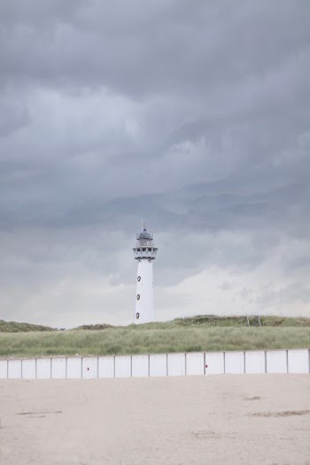 White lighthouse on open field. | Free Photo - rawpixel